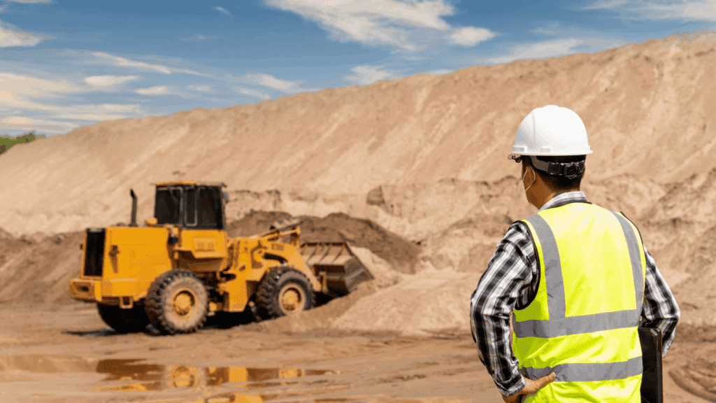Underground construction expert reviewing utility plans on site