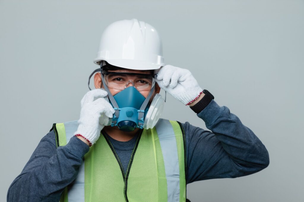 Construction worker in confined space performing safety inspection for civil underground project.