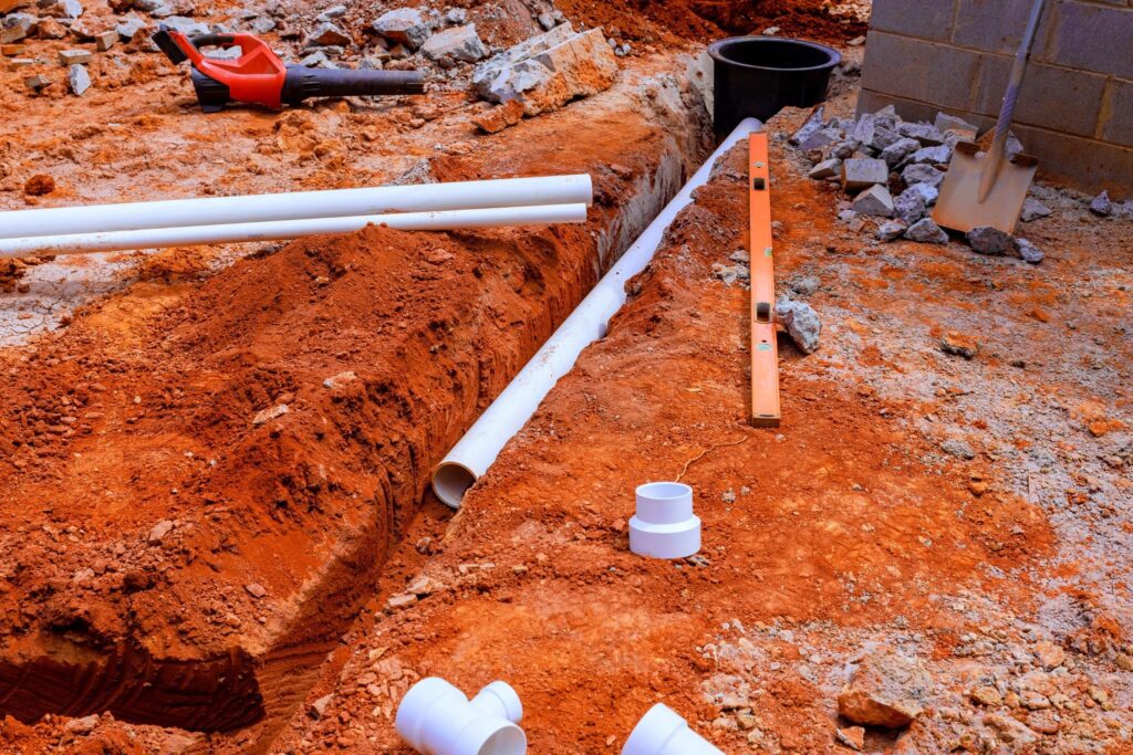 Engineers reviewing underground utility construction plans for accurate take-off and cost analysis