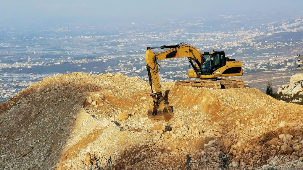 Construction geotechnical engineer evaluating trench stability and soil conditions