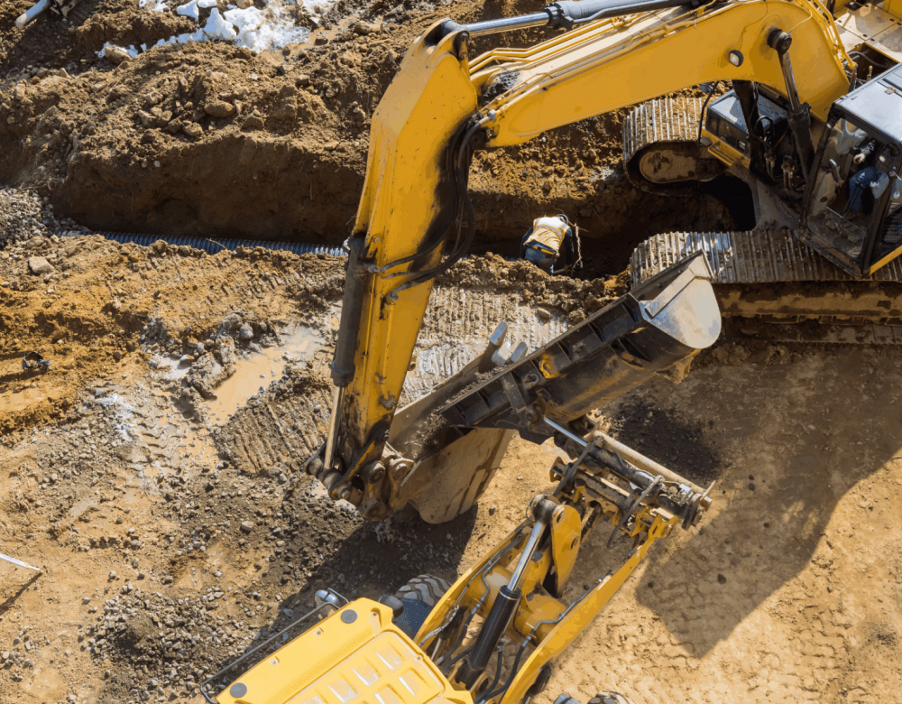 civil-heavy-underground-construction-case-review Aerial view of a heavy underground construction site with trenching and utility installation in progress