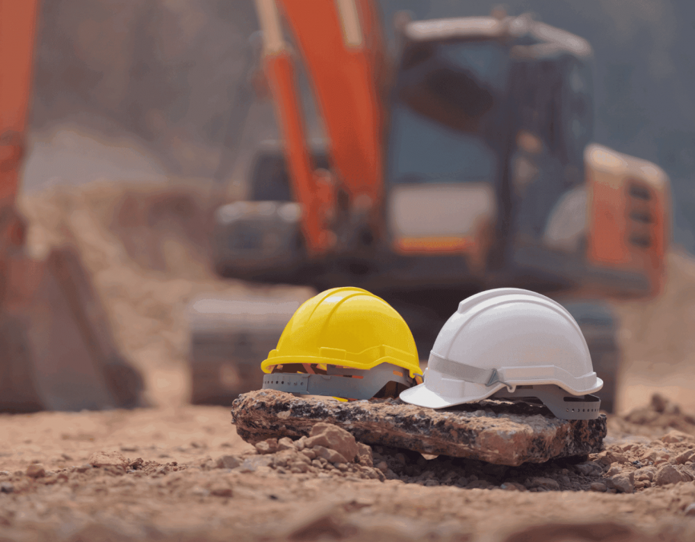 Civil heavy underground construction site showing trenching, heavy equipment, and labor crews