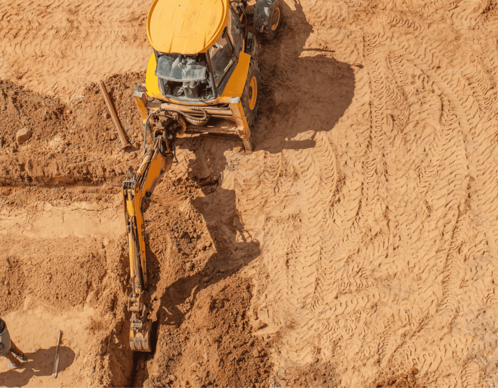 Civil and underground construction litigation expert reviewing utility plans on-site