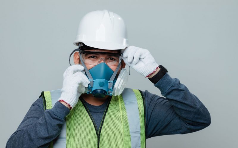 Construction worker in confined space performing safety inspection for civil underground project.