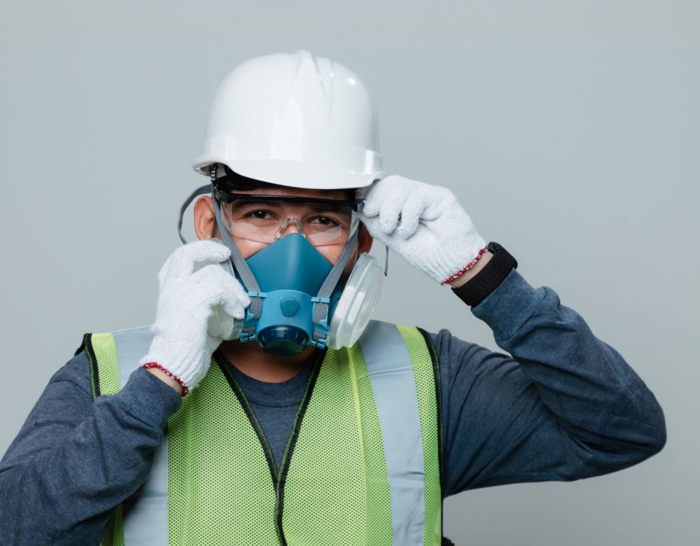 Construction worker in confined space performing safety inspection for civil underground project.