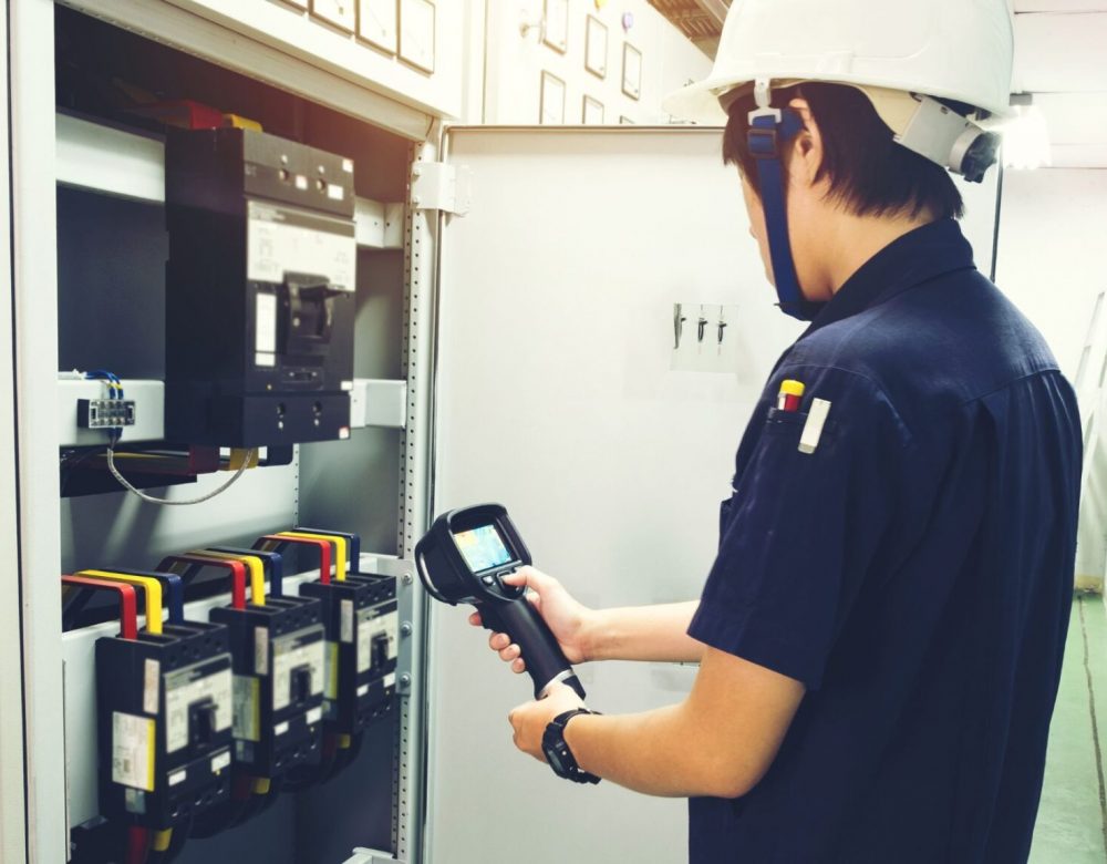 Heavy equipment inspection expert using diagnostic tools on machinery