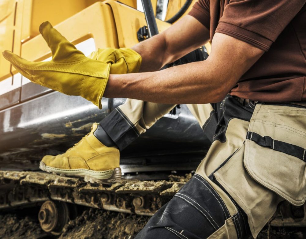 Heavy equipment discovery expert inspecting a construction site with cranes and bulldozers in operation