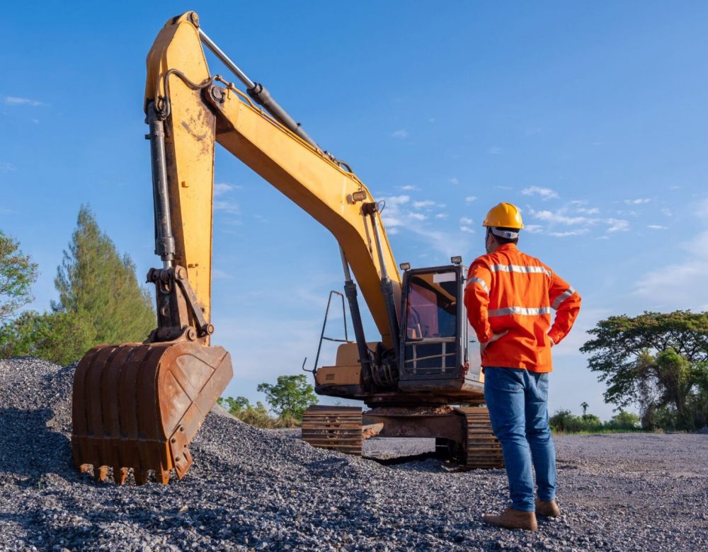 heavy-equipment-site-inspection-featured Heavy equipment site inspection with expert assessing multiple construction machines