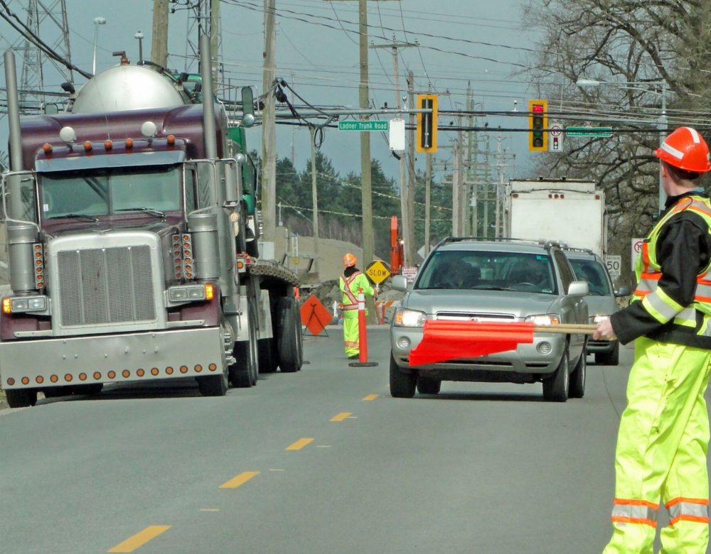 Safety traffic control in civil and heavy construction site with barriers and workers