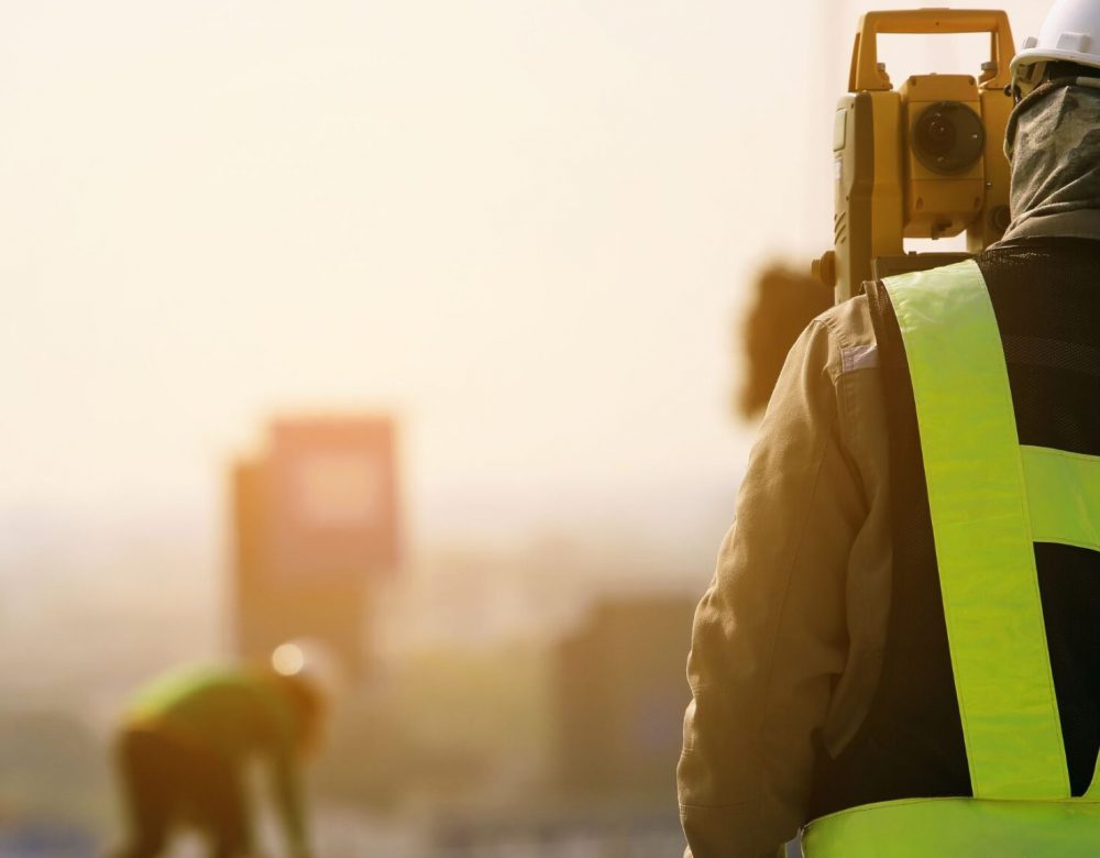 Expert reviewing trenchless construction site with underground utility plans