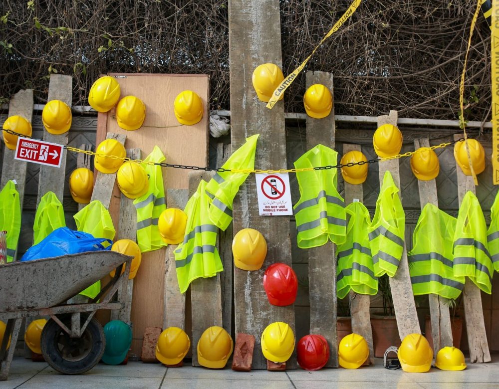 Civil and underground construction work zone with safety signage and workers following OSHA compliance standards